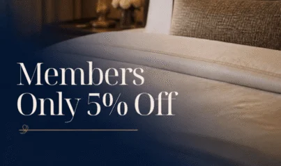 Luxurious hotel room with plush bedding, elegant bedside lamp, and exclusive 5% discount for members displayed.