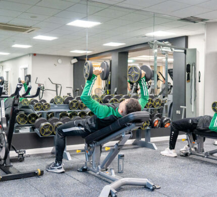 Guests enjoy modern fitness centre with state-of-the-art equipment, mirrored walls, and comfortable workout space.